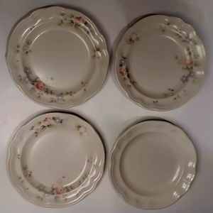 Three Pfaltzgraff salad plates with flower design.  One plain.